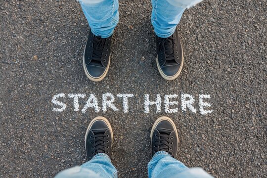 Feet standing at start here line on asphalt road