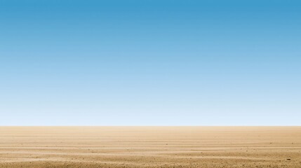 Fototapeta premium Vast, dry desert landscape under a clear blue sky with a flat horizon and no vegetation.
