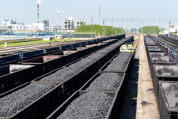 Fototapeta premium Railway coal transportation station - Freight train fully loaded with coal 