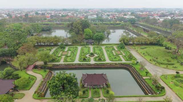 Garden With Symmetrical Design. Balanced Decorative Park Featuring Precise Shapes And Water Features. Elegant Symmetrical Garden Showcasing Landscaped Borders And Serene Water Bodies