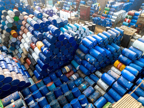 Aerial view of thousands of colorful metal oil drums and chemical barrels stacked in an industrial storage yard Dhaka, Dhaka Division, Bangladesh.