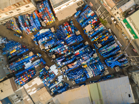 Aerial view of thousands of colorful plastic barrels stacked in an outdoor industrial storage yard in Dhaka, Dhaka Division, Bangladesh.