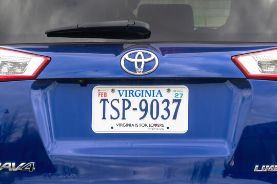 Calgary, Alberta, Canada. May 11, 2026. A close-up of a blue Toyota RAV4 rear showing a Virginia license plate with the "Is For Lovers" slogan.