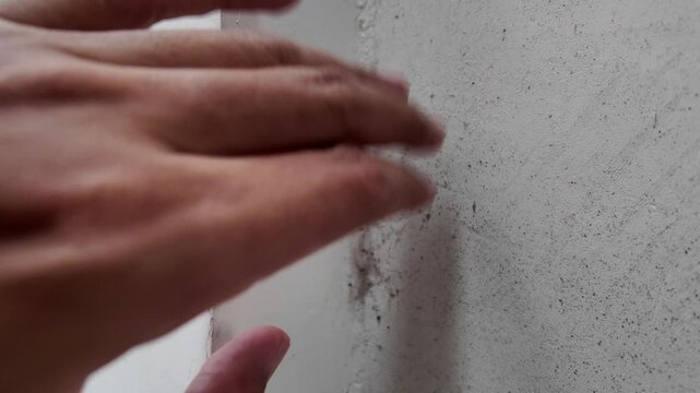 Footage inspecting accumulation of dirt, debris, and cobwebs in a wall corner joint. Ideal for highlighting the need for deep cleaning and home sanitization.