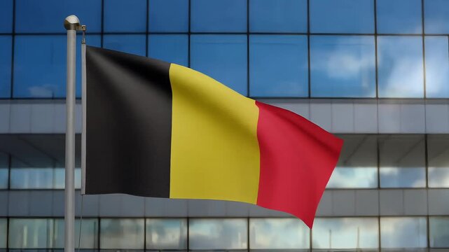 Belgian flag waving in front of a modern glass building on a clear day