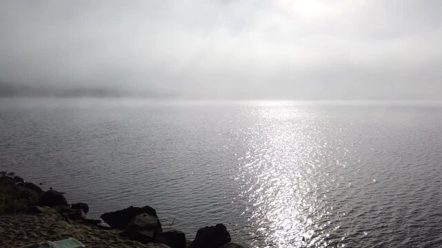 Timelapse shot during a foggy morning on Lac Simon, a beautiful recreational lake in Duhamel, Quebec, Canada. Fog clearing time lapse.