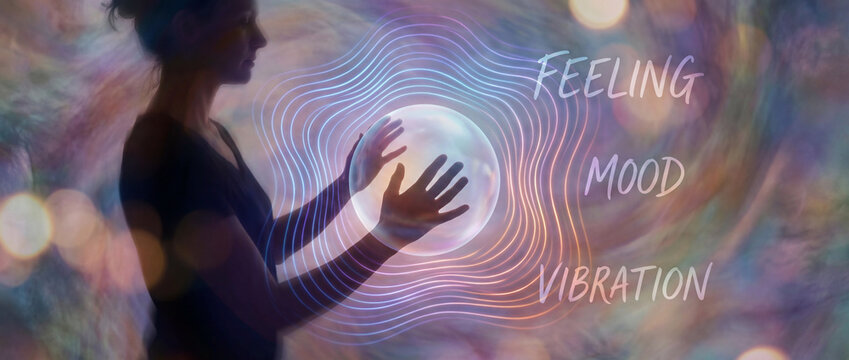 feeling mood vibration openart.ai concept. Silhouette of a woman touching a glowing orb with concentric lines and words feeling, mood, vibration.