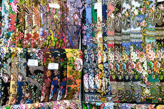 The store features many colorful scarves and shawls with various patterns and patterns.
