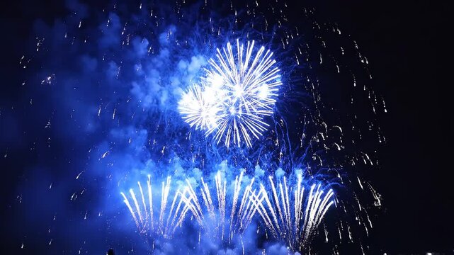 Blue fireworks exploding in night sky symbolizing exploration and the great outdoors
