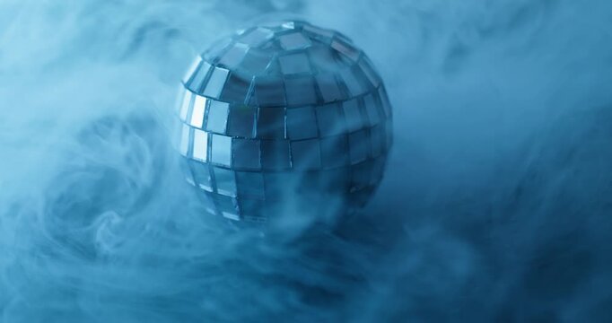Glow disco ball. Blue haze. Blur color creative round texture cold splash fume broken glass water smoke on abstract light background.
