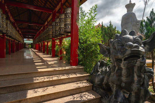 Stone lion prayer wheel corridor Buu Minh Pagoda Pleiku Vietnam