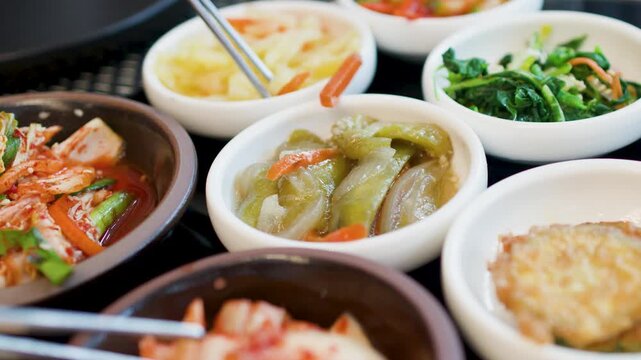 Assorted Korean Banchan Side Dishes Served in Small Ceramic Bowls