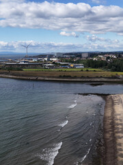 Fototapeta premium Aerial View of Fife Coastline with Beach Sea Wall and Wind Turbine