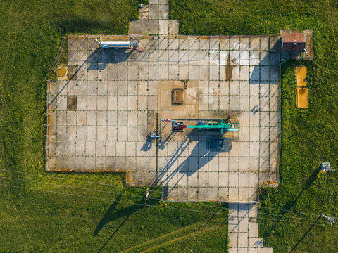 Aerial view of UGS Damborice gas storage facility with industrial machinery and concrete pads surrounded by green fields Damborice, South Moravian Region, Czechia.