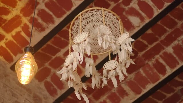 Dream catcher hanging in a cafe with warm light