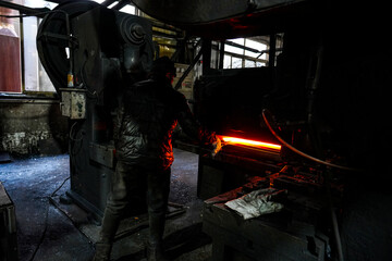 Fototapeta premium Workers in shovel production workshop are working