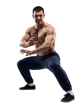 Muscular shirtless man in a martial arts fighting stance