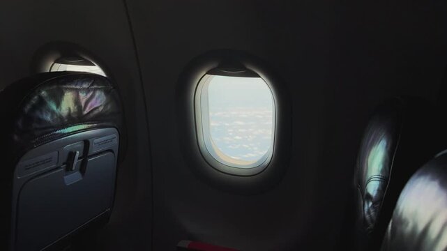 Airplane Cabin Interior Seats and Window View with Cloudy Sky. Free seats on the plane 