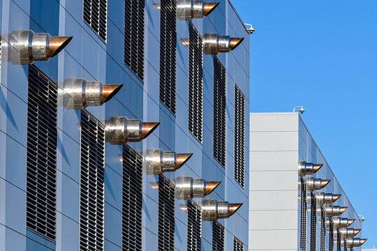 Exterior of a data center facility with ventilation systems and industrial infrastructure, representing cloud computing operations, digital storage, and technology infrastructure