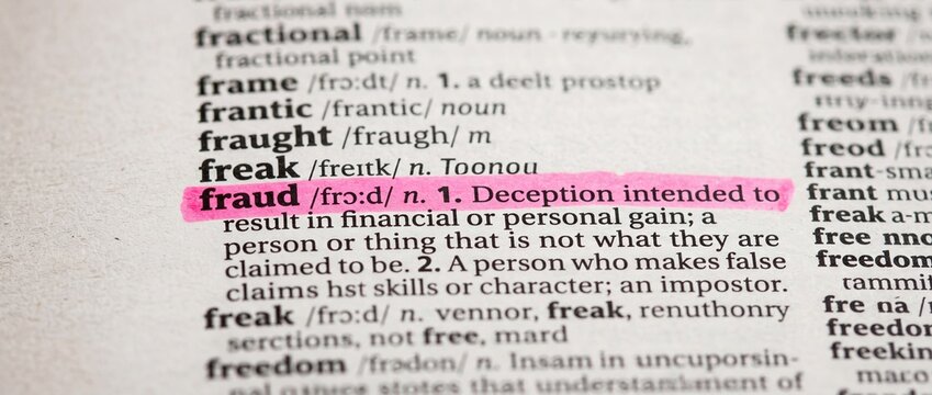 Fraud definition highlighted in dictionary with pink marker