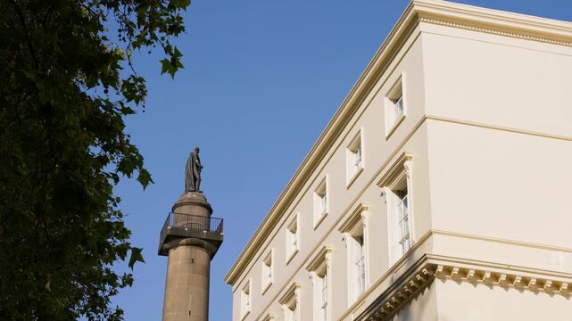 Low-angle shot of the iconic Duke of York Column and statue framed against the grand white fa&ccedil;ade of The Royal Society building on Carlton House Terrace, London. Shot 02