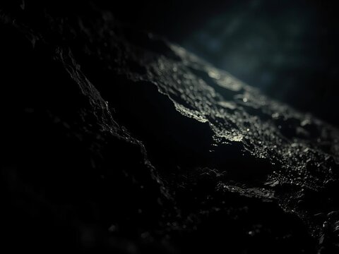 Erosion's art etched in stark relief, a low-angle study of light battling encroaching darkness on granular surfaces,  stark,  dramatic form