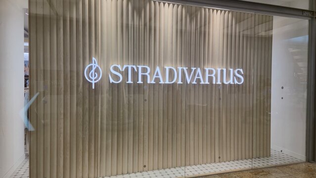 Vilnius Lithuania 09.05.2026 Stradivarius fashion store illuminated logo on elegant wooden wall inside modern shopping mall stylish retail branding and contemporary commercial interior