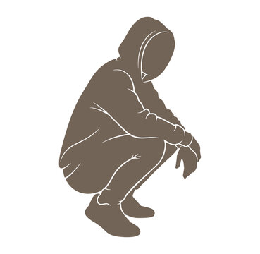 man in hoodie crouching down in squatting position with head down