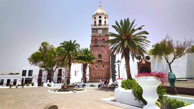 Bell tower of Teguise church in Lanzarote with palm tree
