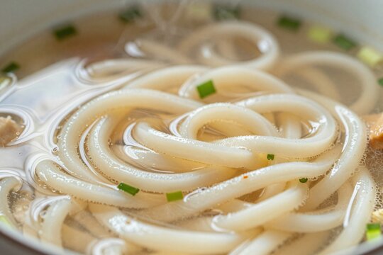 Japanese udon noodles in clear broth, close-up macro shot