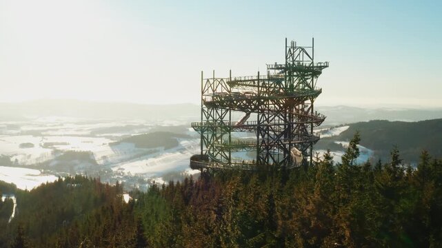 Sky Walk tower overlooking a snowy mountain valley in Dolni Morava, Czech Republic during winter season.