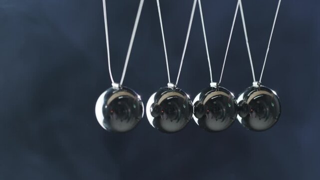 Newton's cradle demonstrating kinetic energy transfer and physics principle.