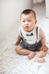 Fototapeta premium Cute Asian boy playing indoors
