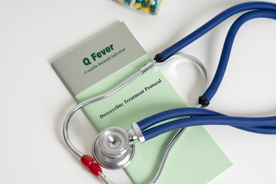 Q fever medical concept with doxycycline treatment protocol booklet and stethoscope