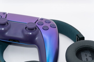 A gamepad for consoles and headphones on a white background, gaming addiction, gaming ban for teenagers, gaming controls for parents, for banners and advertising. High quality © Karen Vardanian