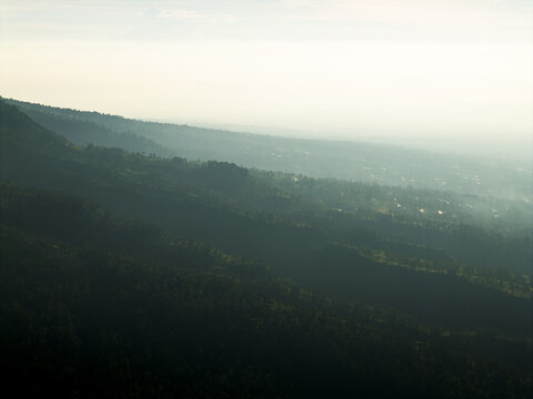 Aerial view of the lush green slopes of Mount Merapi near Bunker Kaliadem with dense tropical forests shrouded in morning mist Kecamatan Pakem, Daerah Istimewa Yogya, Indonesia.