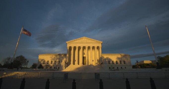 United States Supreme Court with Dramatic Late Afternoon Sky and Flock of Birds Circling Overhead