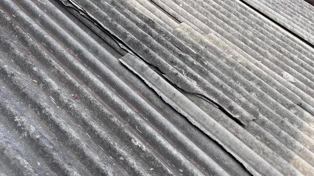 Old damaged asbestos roof texture background with cracks