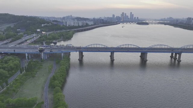 Aerial view of Han River at sunset from Dongjak, featuring subway trains on the bridge, Seoul, South Korea.