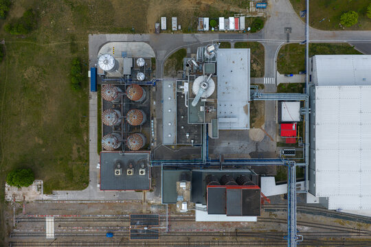 Aerial view of an industrial facility featuring silos, complex piping systems, and a large warehouse building Breclav, South Moravian Region, Czechia.