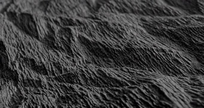 Crumpled Texture with Linear Motion. Video showing dynamic movement over a dark rough texture with crumpled details.