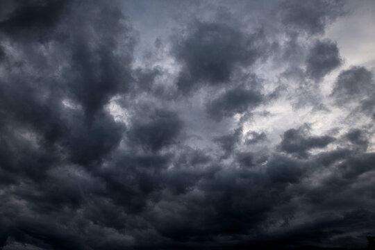 Thunderous dark sky with black clouds and flashing lightning. Panoramic view. Concept on the theme of weather, natural disasters, storms, typhoons, tornadoes, thunderstorms, lightning, lightning.