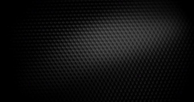 Close-up of black carbon fiber weave with subtle light shift, creating a high-tech, endlessly background. 