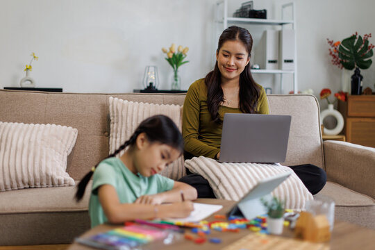 Mother and daughter working studying from home