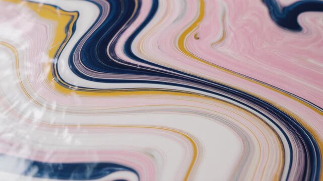 A swirling abstract pattern of colorful lines flows gently across the surface.