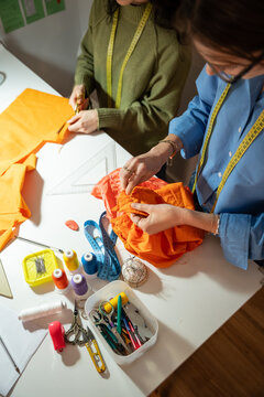 From above view of women sewing garment in fashion atelier