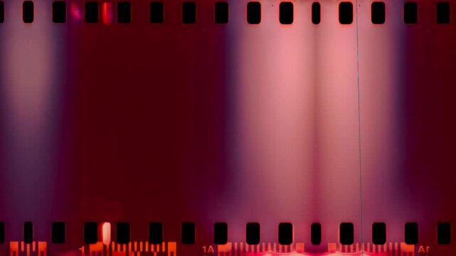 Purple Light Burn negative film strip on green screen chroma key background. colorful transition style stock footage for cinematic video editing and creative media projects. element motion