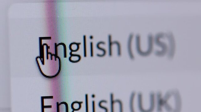 4K macro shot of a cursor clicking a globe icon to select a language, showing English (US) and English (UK) options.