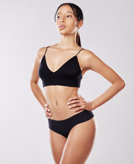 Fototapeta premium Studio, woman and thinking of body with underwear for wellness, progress and healthy nutrition. Stomach, diet and female person with confident for results, weight loss and slim on white background