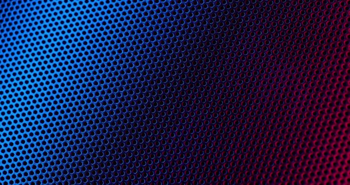Color Perforated surface texture. Close-up view of a color perforated surface with a repeating hole pattern, creating a textured and industrial look.
